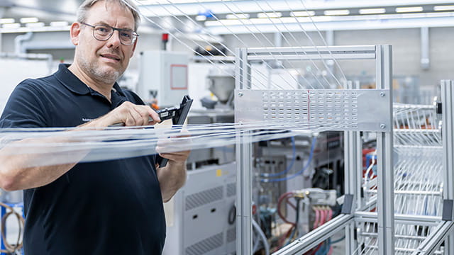 Pultrusion person checking fibres