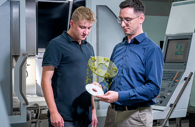 people watching machined part