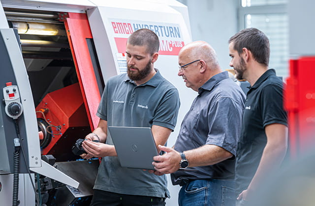 people checking machining parameters