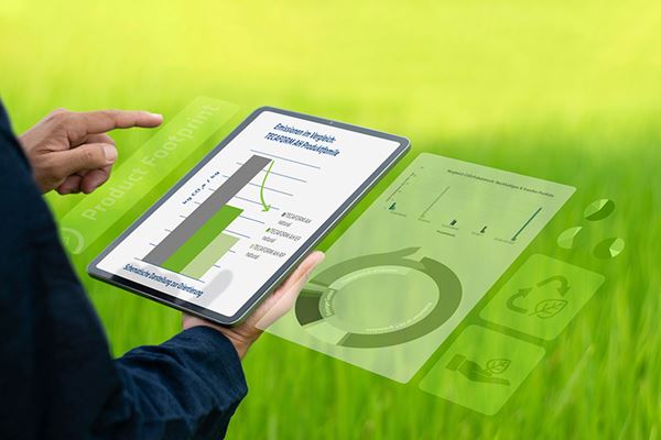 Man holding a tablet with diagrams in nature